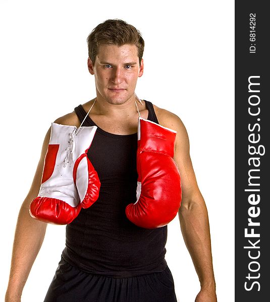 A boxer in workout clothes and red boxing gloves isolated on white. A boxer in workout clothes and red boxing gloves isolated on white