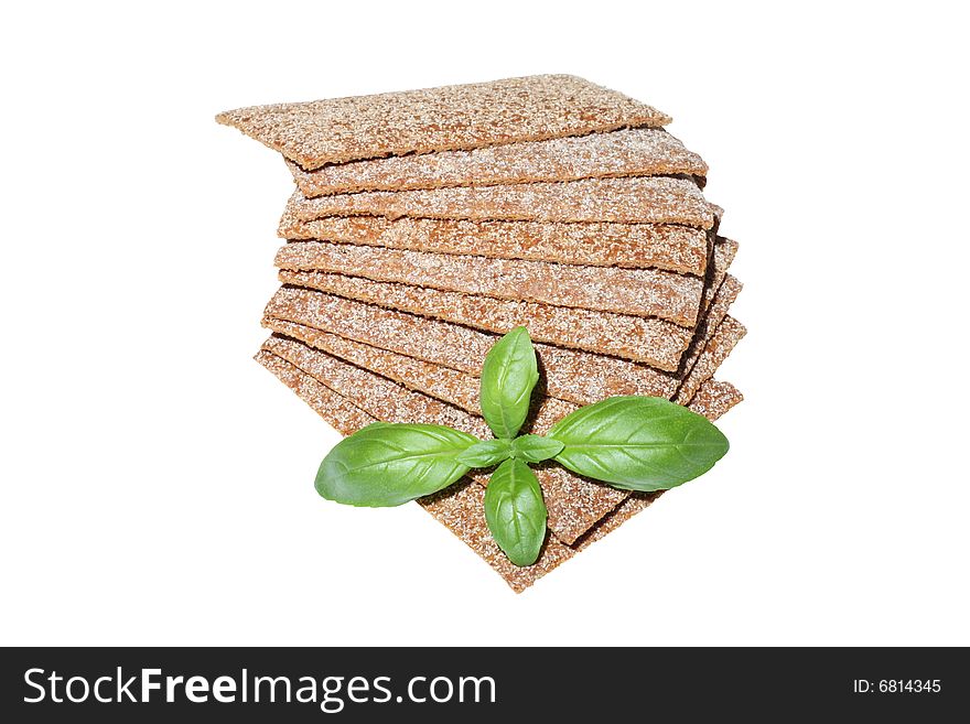 Crispbread slices with basil isolated on white background