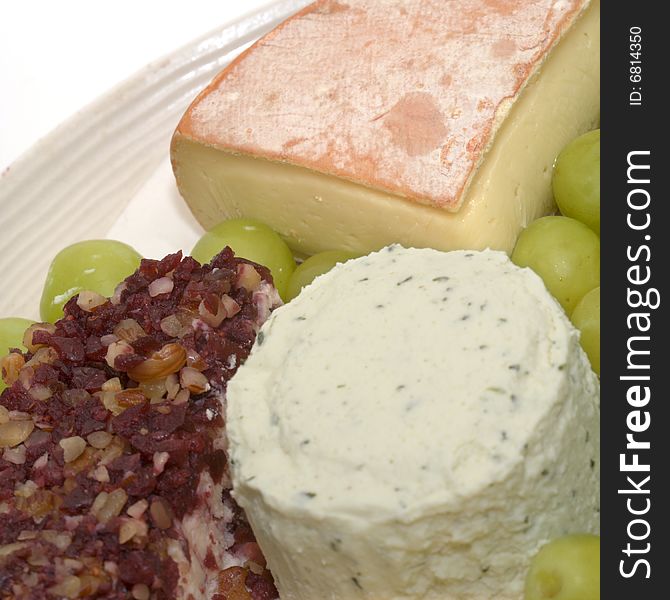 Three different soft cheeses and green grapes. Three different soft cheeses and green grapes
