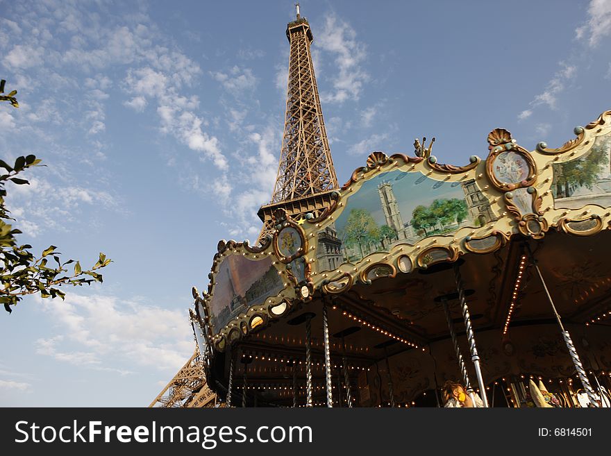 The Eiffel Tower shot against the blue sky and carrousel. The Eiffel Tower shot against the blue sky and carrousel