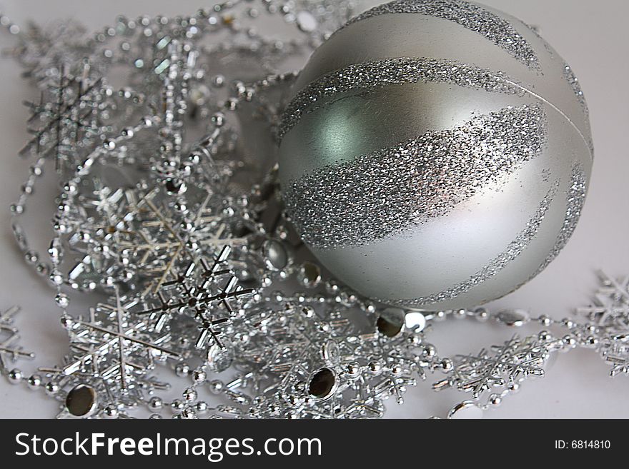 The striped sphere lays on brilliant snowflakes