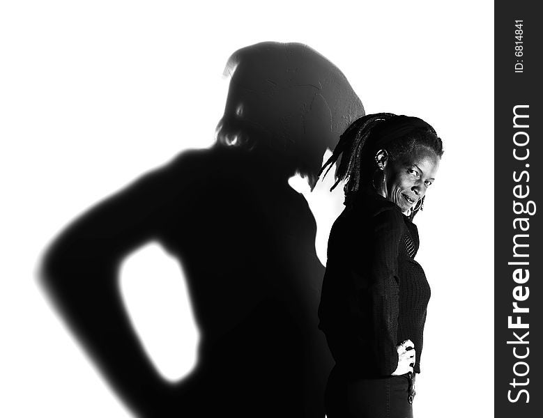 African American woman with dreadlocks against a white wall. African American woman with dreadlocks against a white wall