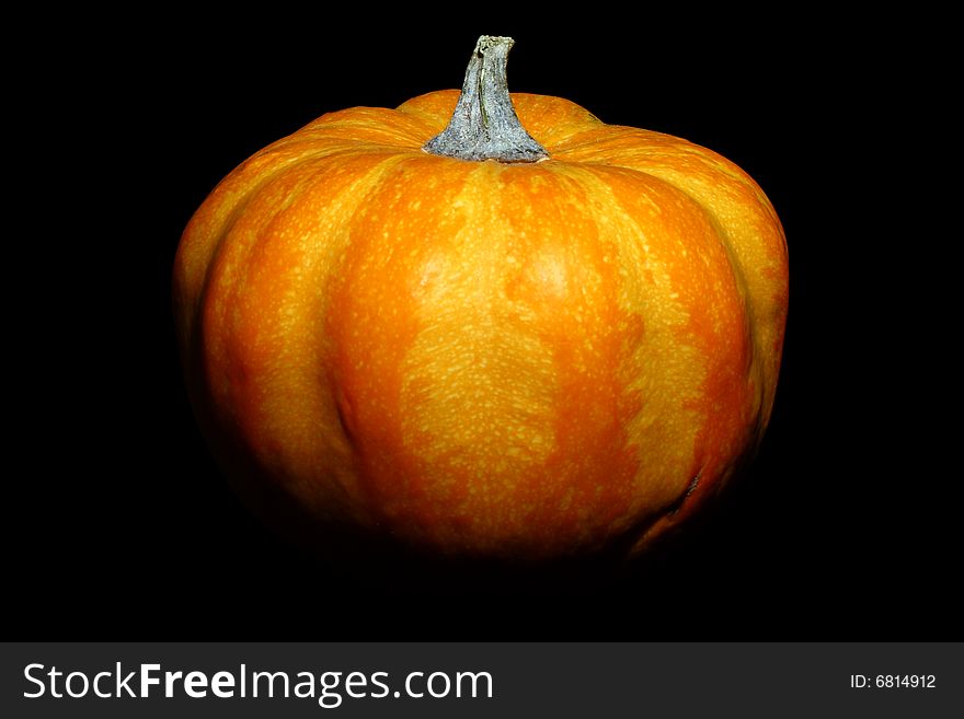 A perfectly isolated orange pumpkin on a black background. A perfectly isolated orange pumpkin on a black background