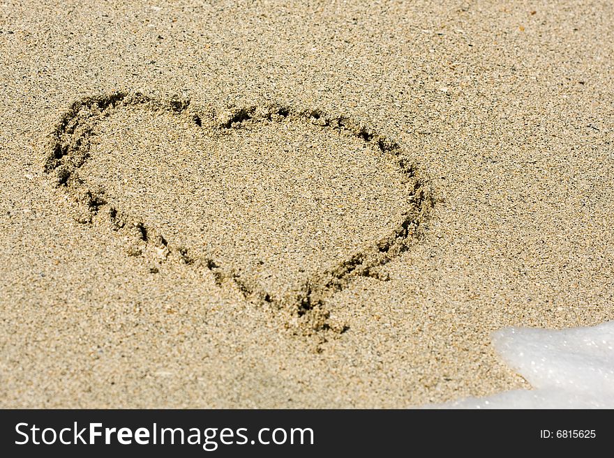 Heart sign written on wet sand. Heart sign written on wet sand