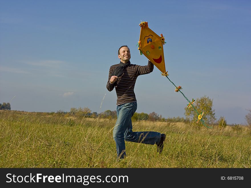 Autumn freetime guy flying a kite. Autumn freetime guy flying a kite