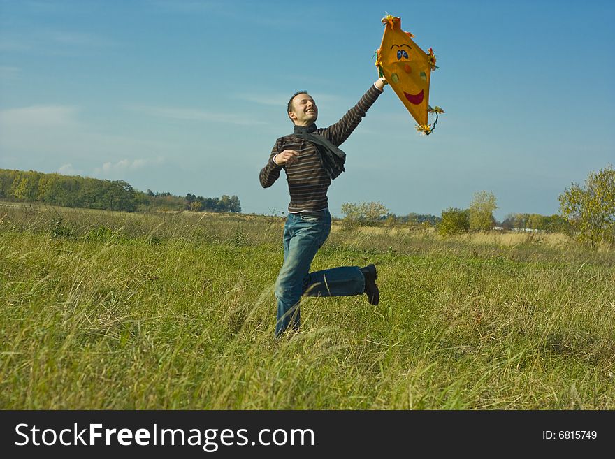 Man feeling free while running and flying a kite. Man feeling free while running and flying a kite