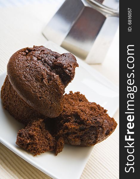 Fresh chocolate muffin on a white plate