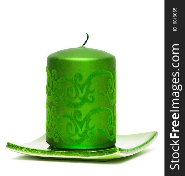 Green burning candle on white background