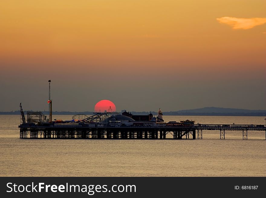 Sunset behind the Palace Pier in Brighton, England. Sunset behind the Palace Pier in Brighton, England