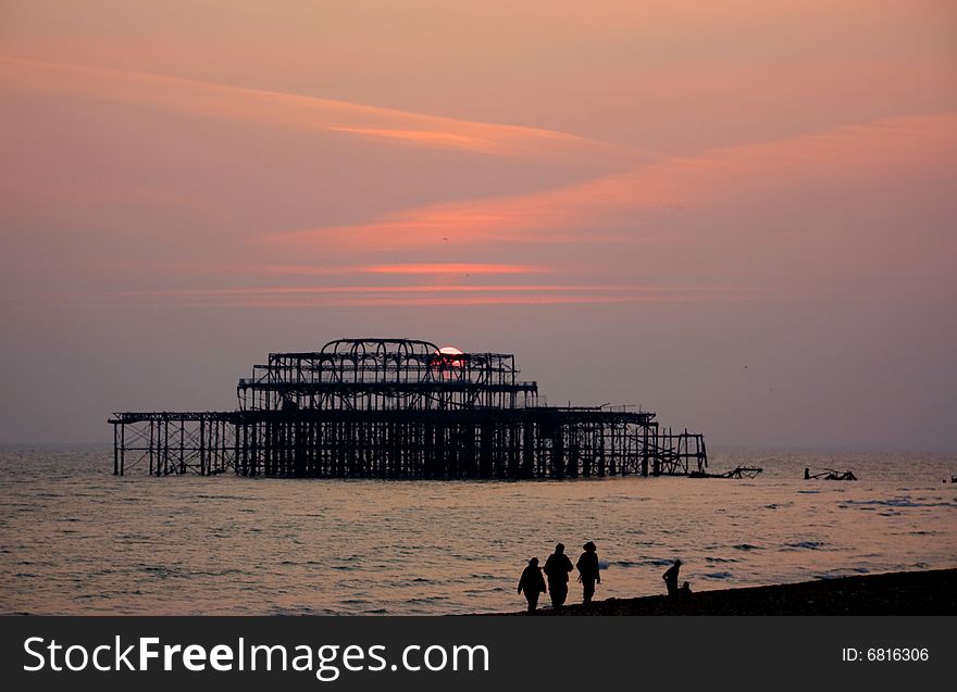 Burnt down West Pier in Brighton, England at sunset