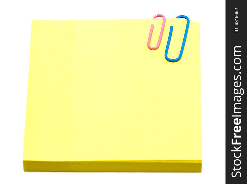 Yellow pages of notebook with paper clip on white