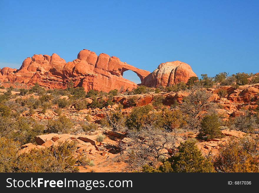 View of the red rock formations in Arches National Park with blue skyï¿½s. View of the red rock formations in Arches National Park with blue skyï¿½s