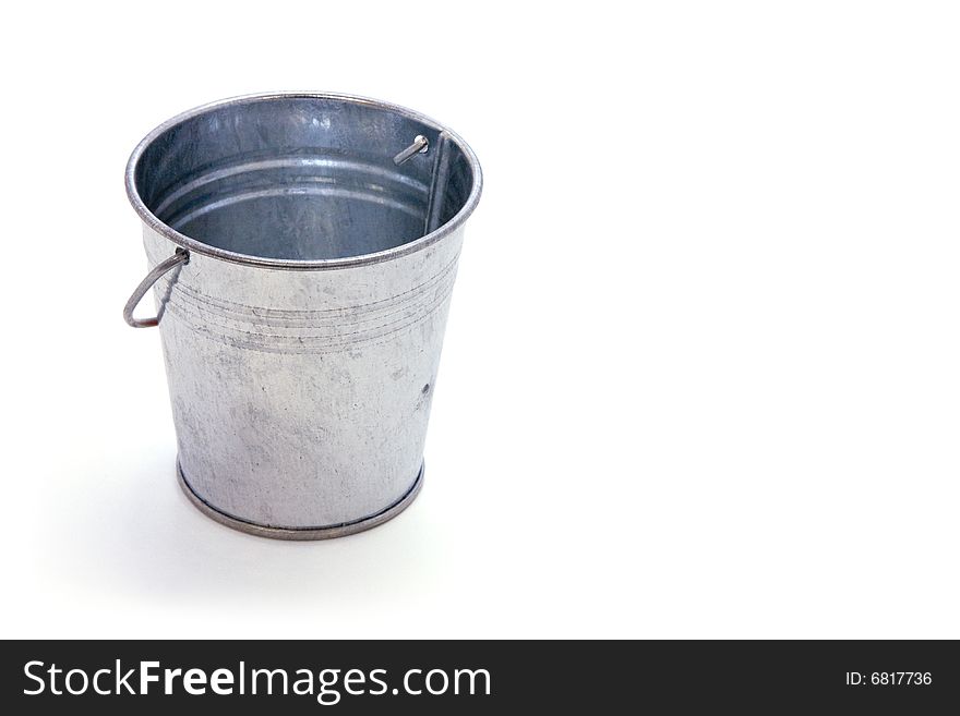 Galvanized metal bucket with shadow on white field. Galvanized metal bucket with shadow on white field