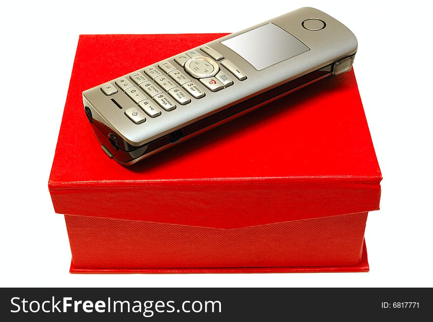 Gray (silver) mobile (radio) telephone and red cardboard box on isolated background. Gray (silver) mobile (radio) telephone and red cardboard box on isolated background.