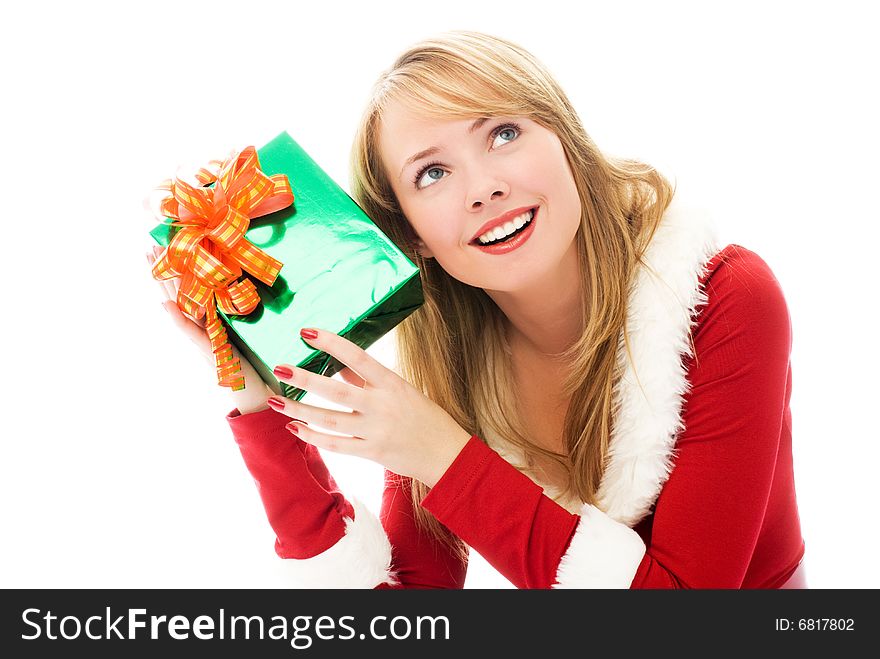 Beautiful girl dressed as Santa shaking a Christmas present. Beautiful girl dressed as Santa shaking a Christmas present