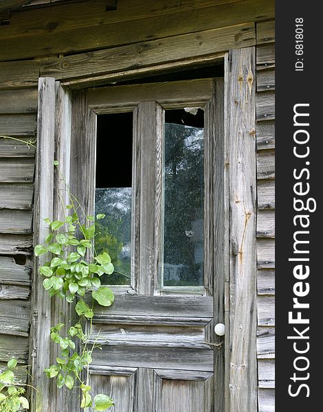 Wooden door with broken glass in a warped door frame. Wooden door with broken glass in a warped door frame