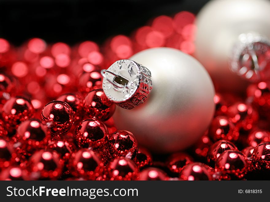 White and red christmas ornaments on black background