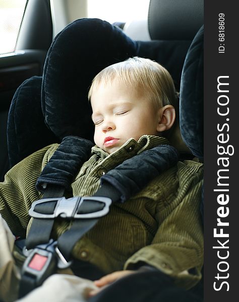 Child is buckled into his car seat and finds the drive quite exhausting. Child is buckled into his car seat and finds the drive quite exhausting.