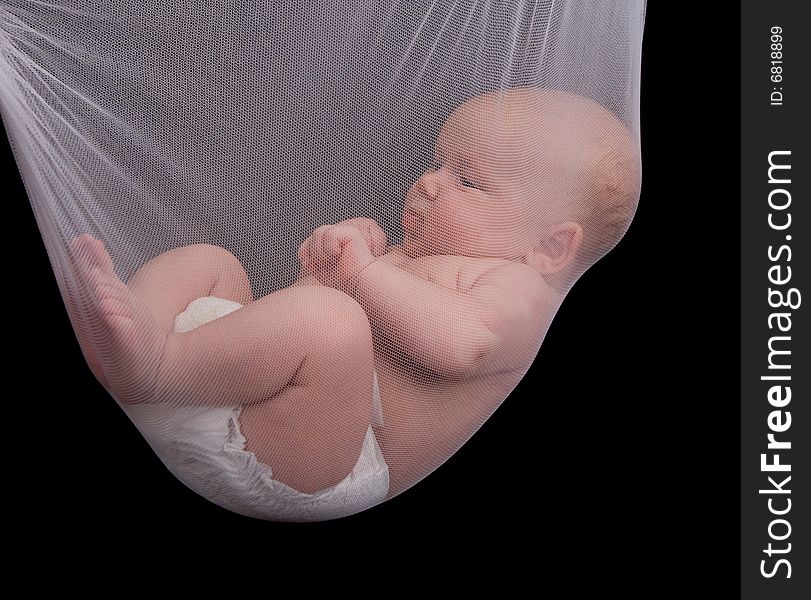 Little baby hold in the net over black background. Little baby hold in the net over black background