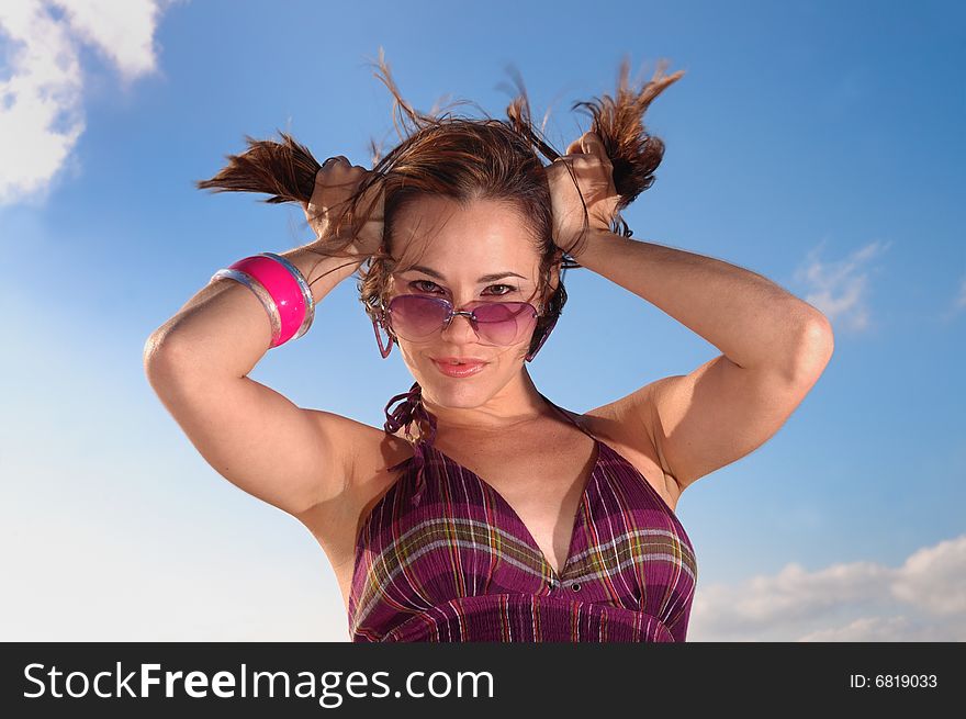 Portrait of young trendy female holding her hair. Portrait of young trendy female holding her hair