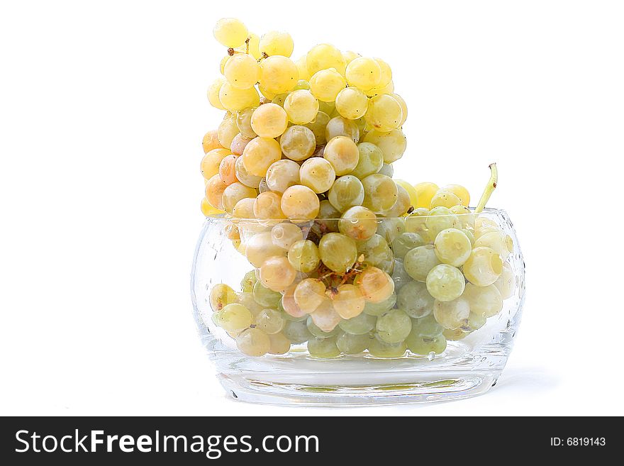 Close-up of grapes in a glass bowl on white background. Close-up of grapes in a glass bowl on white background