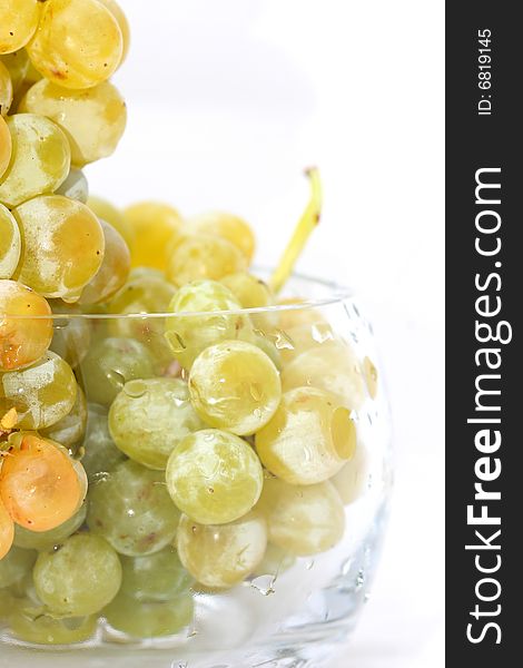 Close-up of grapes in a glass bowl on white background. Close-up of grapes in a glass bowl on white background