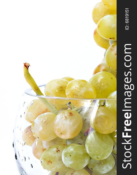 Close-up of grapes in a glass bowl on white background. Close-up of grapes in a glass bowl on white background