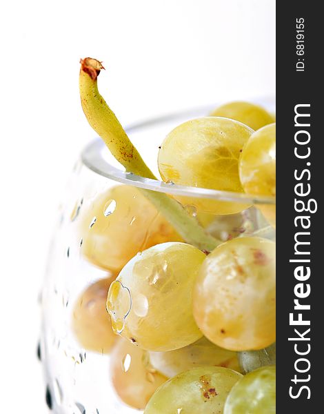 Close-up of grapes in a glass bowl on white background. Close-up of grapes in a glass bowl on white background