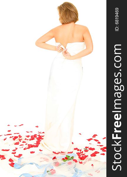 Happy beautiful caucasian bride in her gown standing with rose petal around her. Happy beautiful caucasian bride in her gown standing with rose petal around her