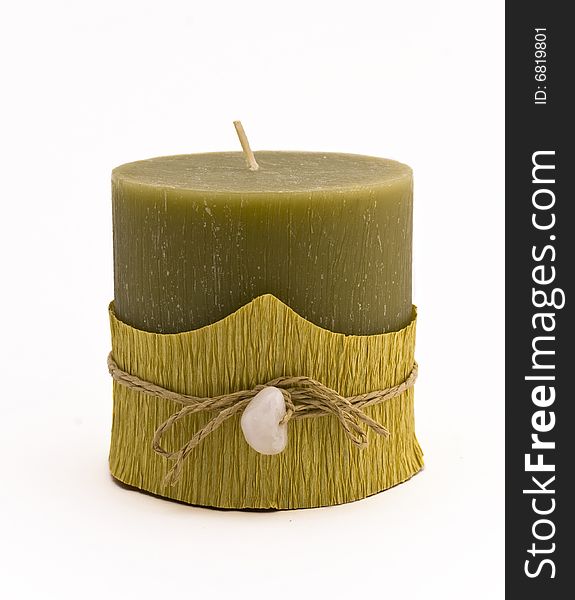 Green candle with stone close-up isolated