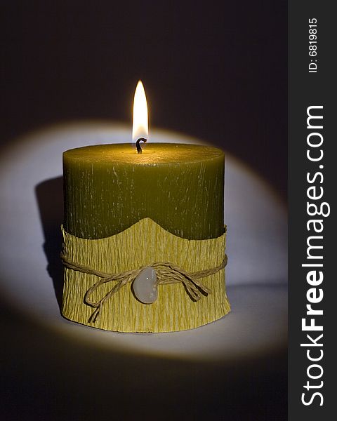 Green candle with stone close-up isolated