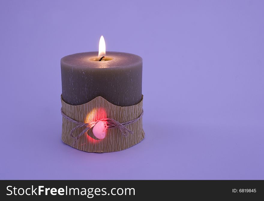 Candle with stone close-up isolated