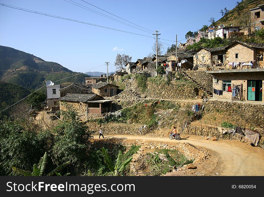 This photo was taken in Xiamen City, Fujian Province, China in a mountain village. Backing the construction of residential and winding road, showing the obvious geographical characteristics of China's south-eastern hilly areas of the village character. This photo was taken in Xiamen City, Fujian Province, China in a mountain village. Backing the construction of residential and winding road, showing the obvious geographical characteristics of China's south-eastern hilly areas of the village character
