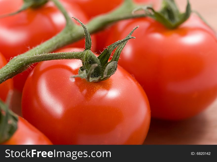 Ripe tomatoes on branch background. Ripe tomatoes on branch background