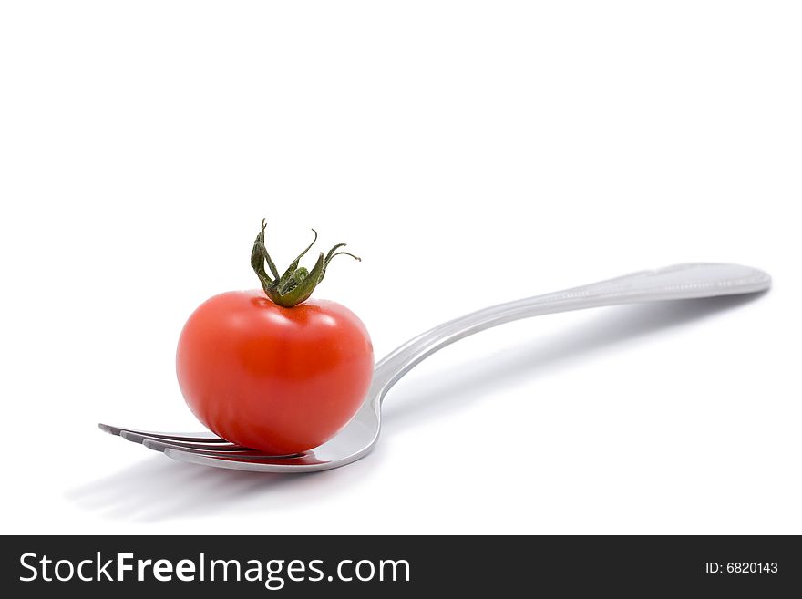 Red Tomato On A Fork Isolated