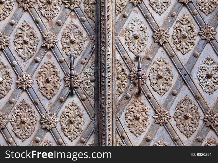 Door-handle decoration detail of old metal iron entrance door in Prague Little quarter. Door-handle decoration detail of old metal iron entrance door in Prague Little quarter.