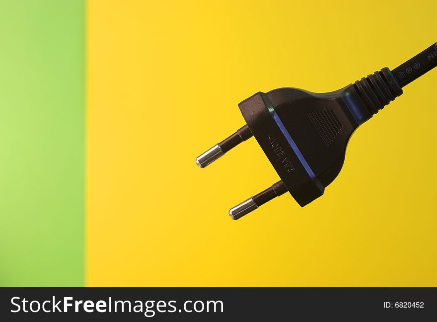 An  electricity fuse adapter in a simple yellow background. An  electricity fuse adapter in a simple yellow background