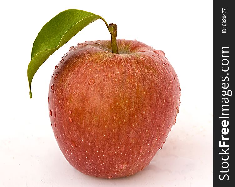 Red apple in water droplets