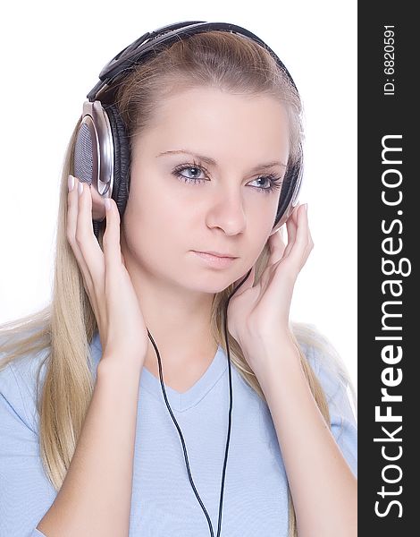 Isolated smiling young girl listening to music. Isolated smiling young girl listening to music