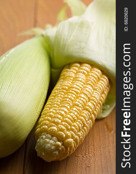 Fresh maize with water droplets on a table