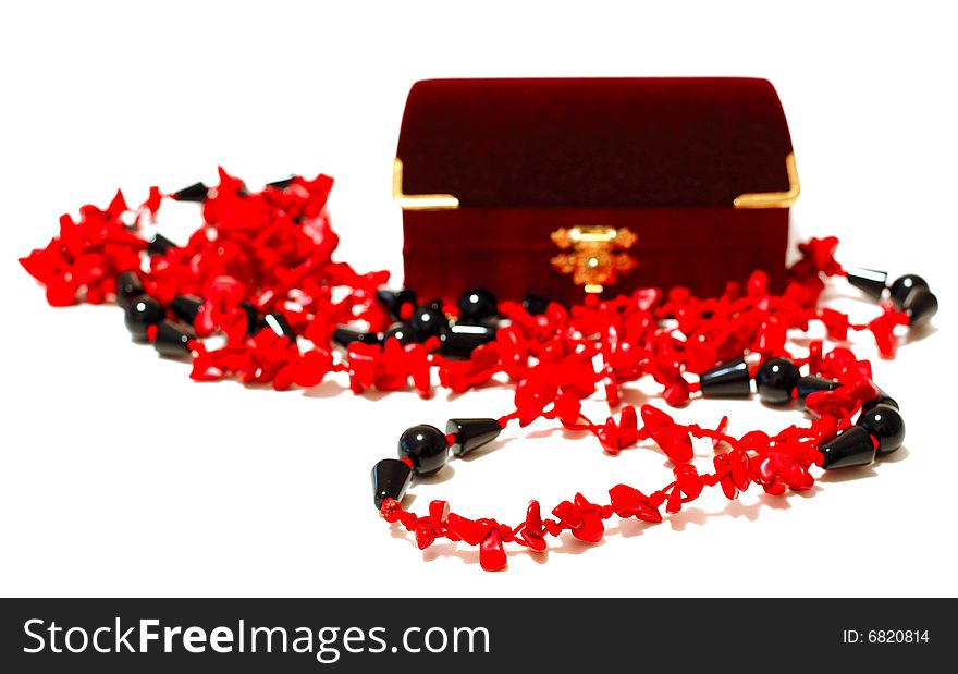 Bright coral red and black beads (necklace) and crimson velvet box for jewelry (jewellery) on isolated background. Bright coral red and black beads (necklace) and crimson velvet box for jewelry (jewellery) on isolated background.