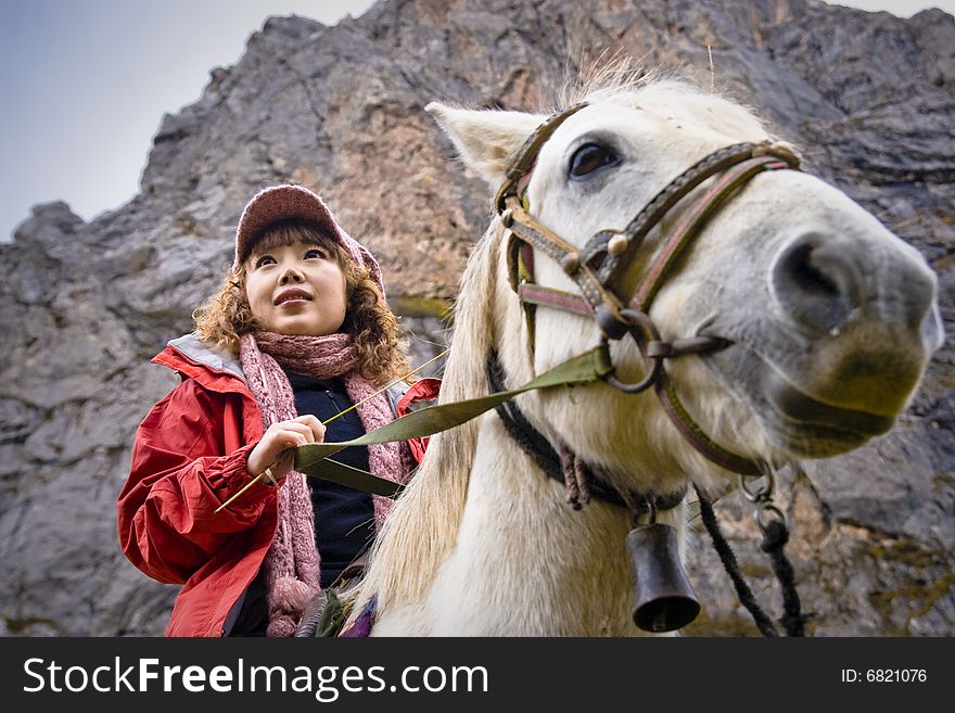 The girl riding a horse