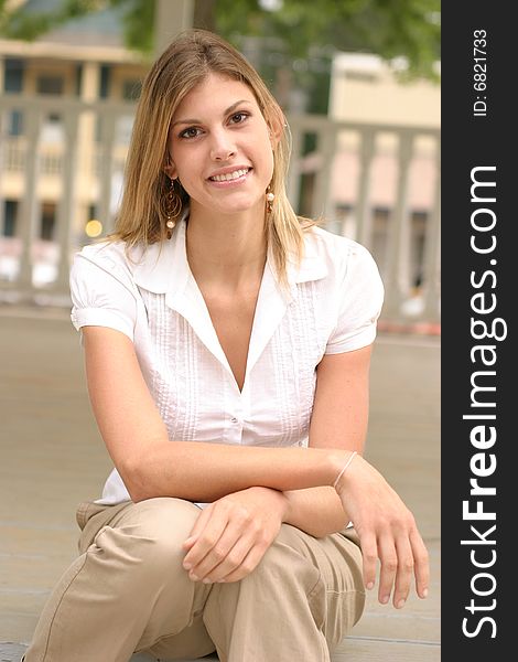 Young woman posing outside wearing a white top