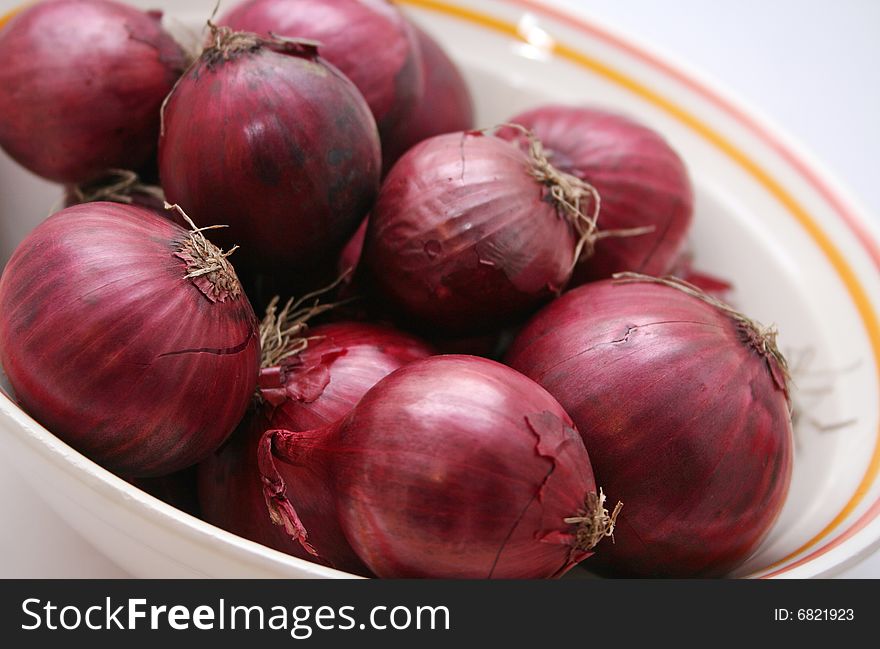 A lot of red onions in a bowl
