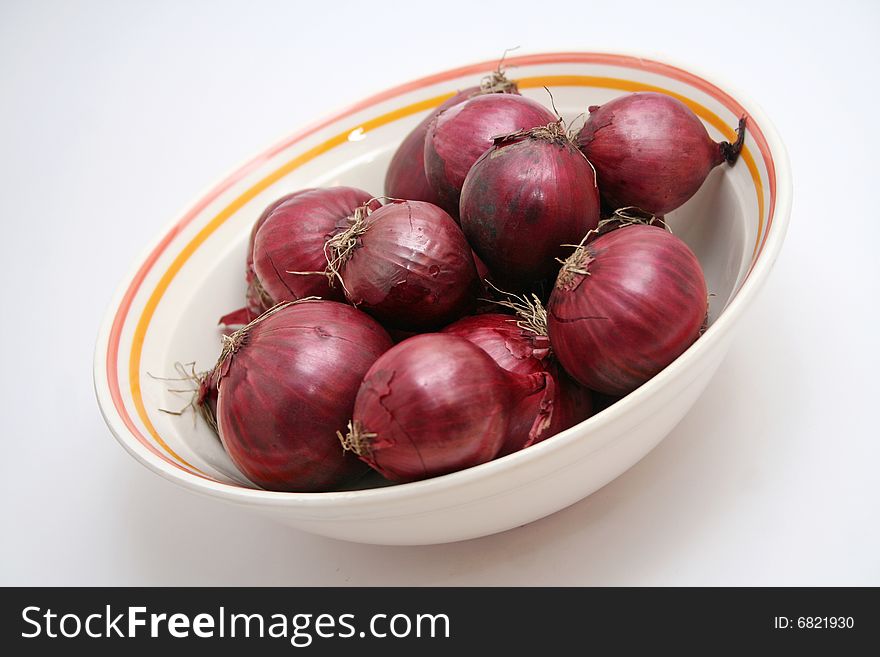 A lot of red onions in a bowl