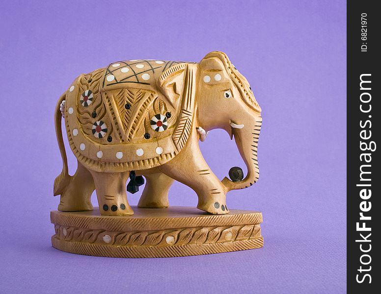 Elephant figurine close-up isolated on violet background