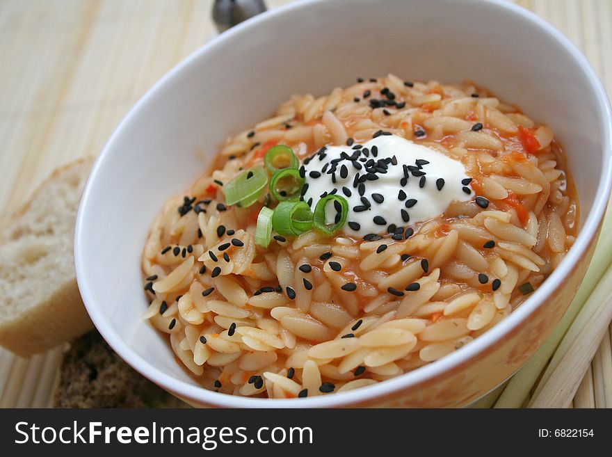 A meal of rice noodles with tomato sauce