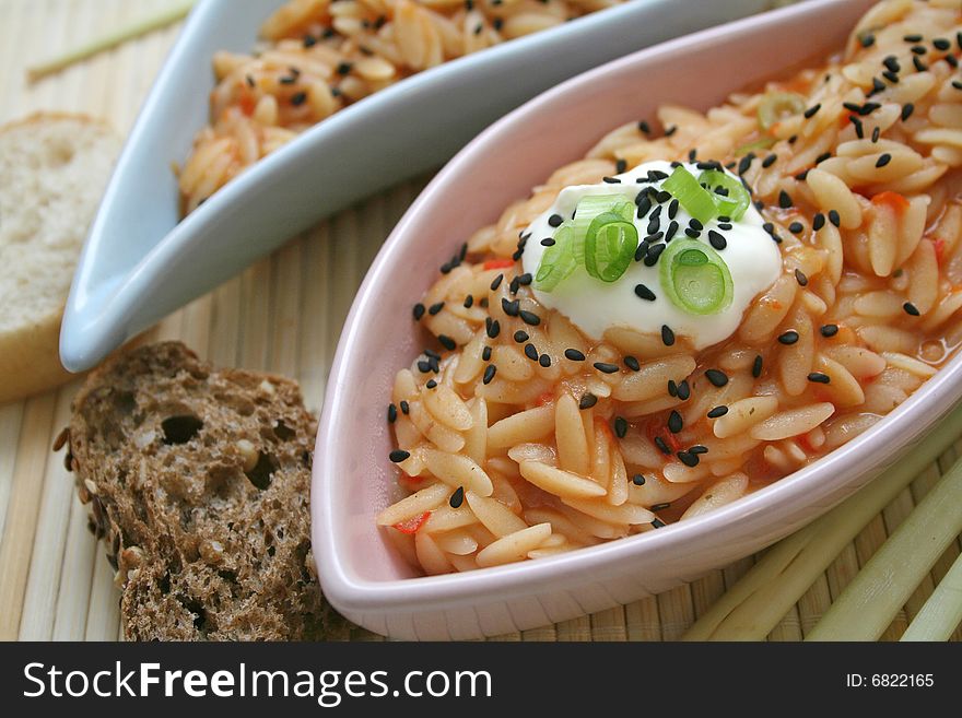 A meal of rice noodles with tomato sauce