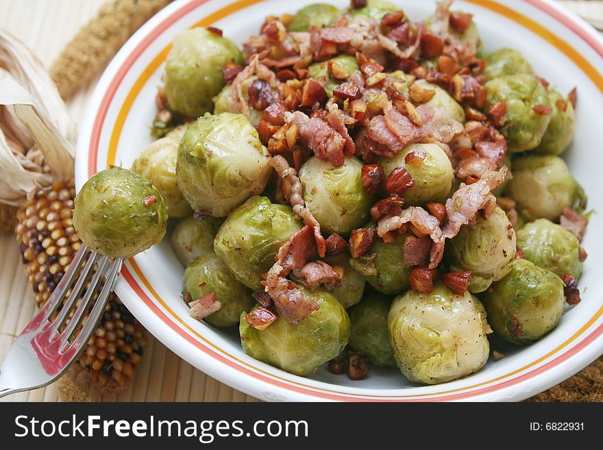 A meal of cabbage with almonds, bacon and some cheese