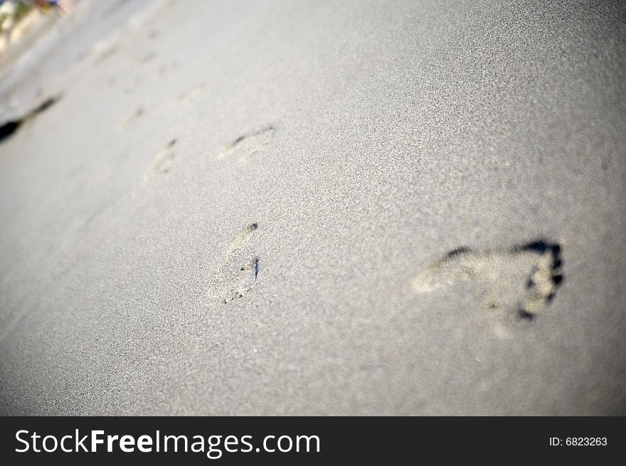 Few footprints on gray sand. Few footprints on gray sand